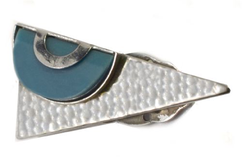 fig 1. An Art Deco geometric dress clip featuring a textured silver-tone metal triangle overlaid with a teal semi-circular plastic insert.