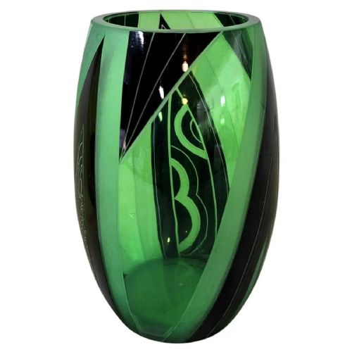 fig 1. A barrel-shaped green uranium glass vase featuring geometric black enamelled and frosted panels in an Art Deco design.