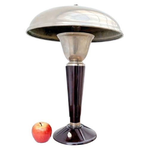 fig 1. An Art Deco desk lamp featuring a polished nickel domed shade over a flared stem and a fluted dark brown Bakelite column on a circular base.