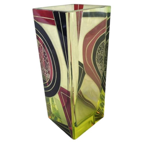 fig 1. A tall, rectangular Art Deco uranium glass vase featuring geometric red and black enamel decorations alongside etched panel detailing.