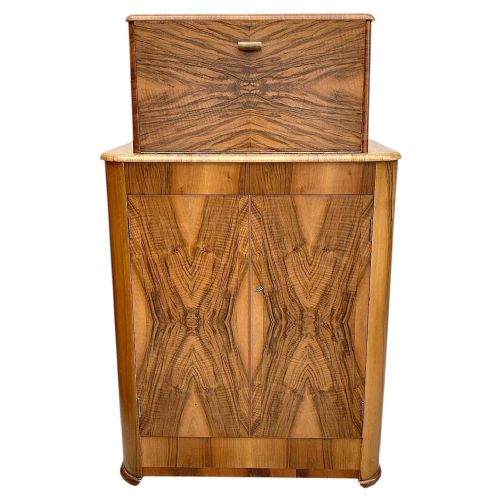 fig 1. An Art Deco upright walnut cocktail cabinet featuring book-matched veneer doors and an open top compartment with a mirrored interior.
