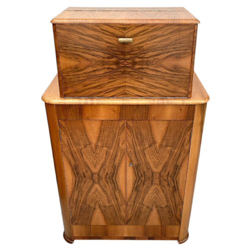 fig 2. An Art Deco upright walnut cocktail cabinet featuring book-matched veneer doors and an open top compartment with a mirrored interior.