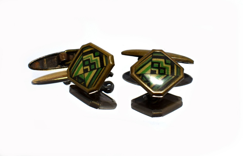 A pair of Art Deco gents cufflinks featuring octagonal faces inlaid with geometric green, black, and yellow enamel patterns framed in brass metal. View II