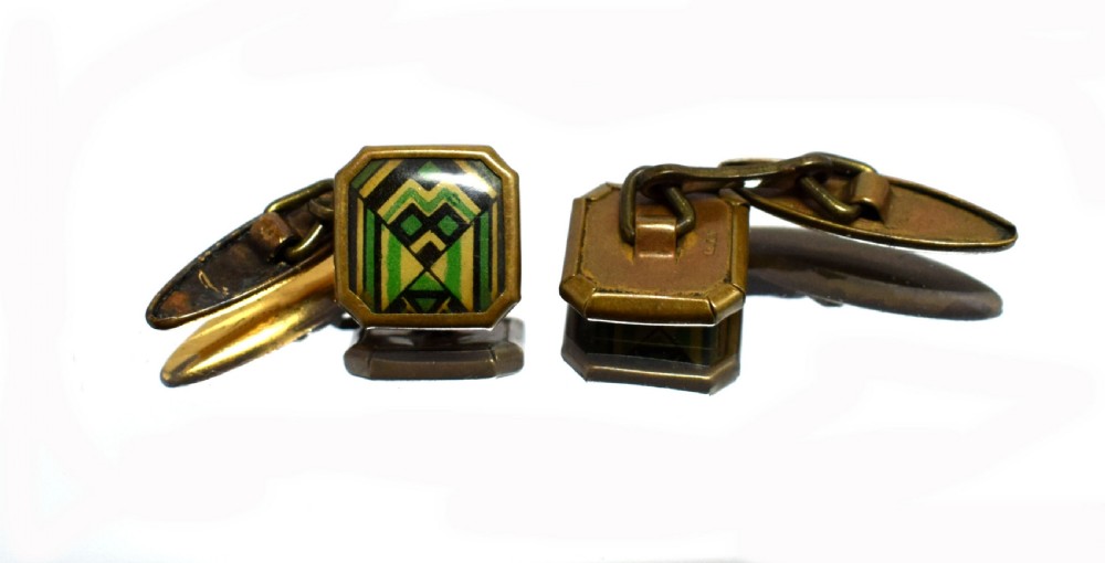 A pair of Art Deco gents cufflinks featuring octagonal faces inlaid with geometric green, black, and yellow enamel patterns framed in brass metal. View III