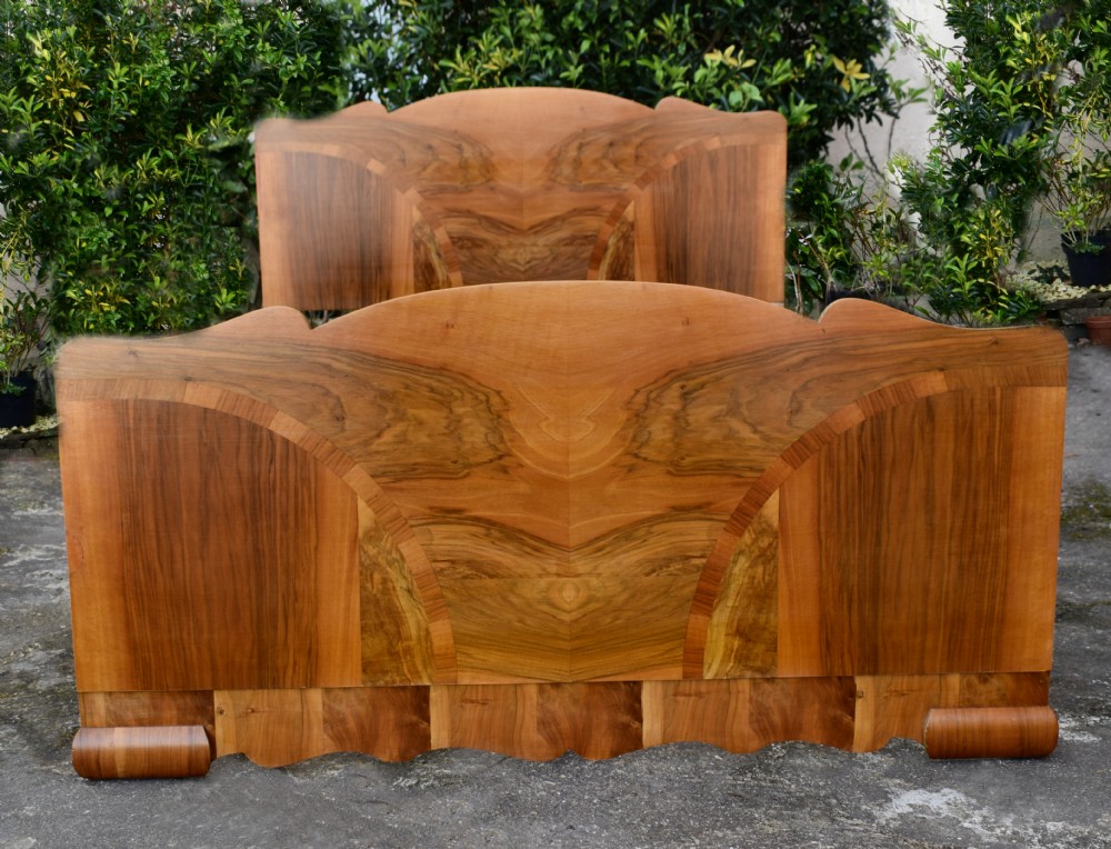 An Art Deco double bed frame featuring an arched cloud-shaped headboard and matching footboard with symmetrical book-matched walnut veneer. View III