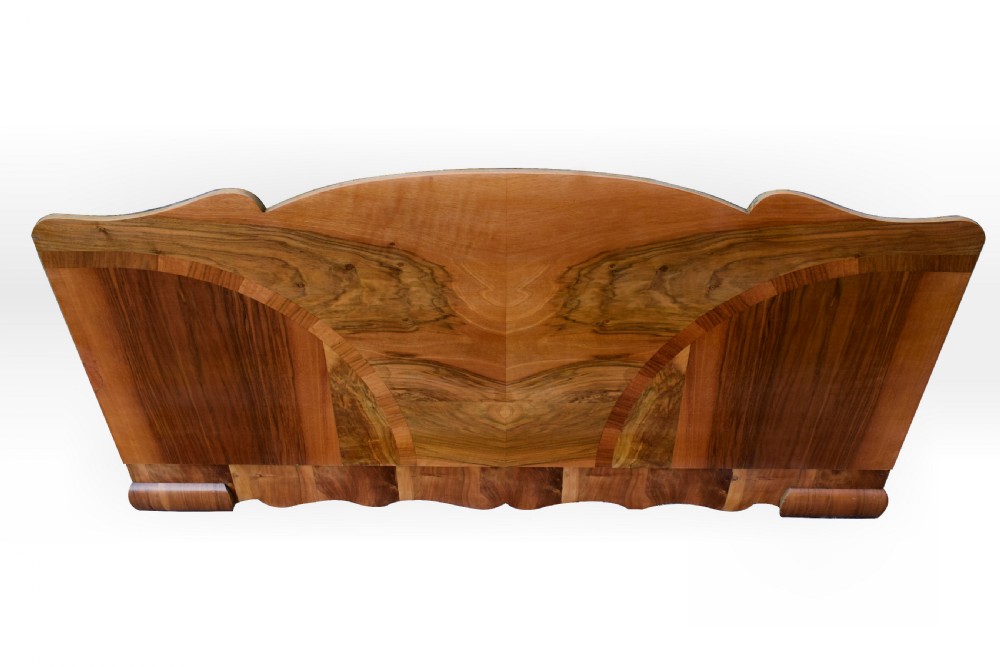 An Art Deco double bed frame featuring an arched cloud-shaped headboard and matching footboard with symmetrical book-matched walnut veneer. View VI