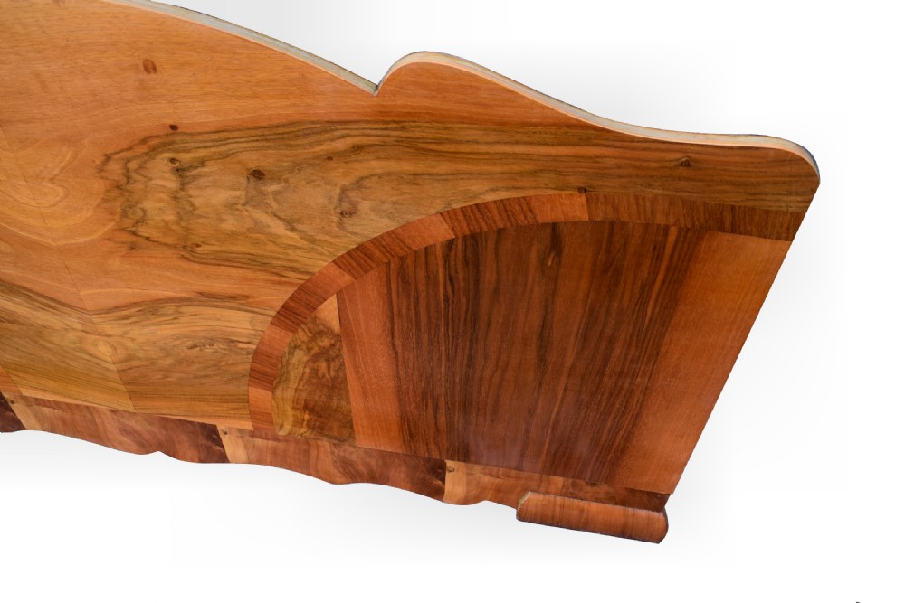 An Art Deco double bed frame featuring an arched cloud-shaped headboard and matching footboard with symmetrical book-matched walnut veneer. View VII