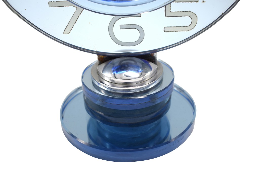 A circular Art Deco table clock made from blue mirrored glass featuring silvered numbers and a stepped circular glass base. View II