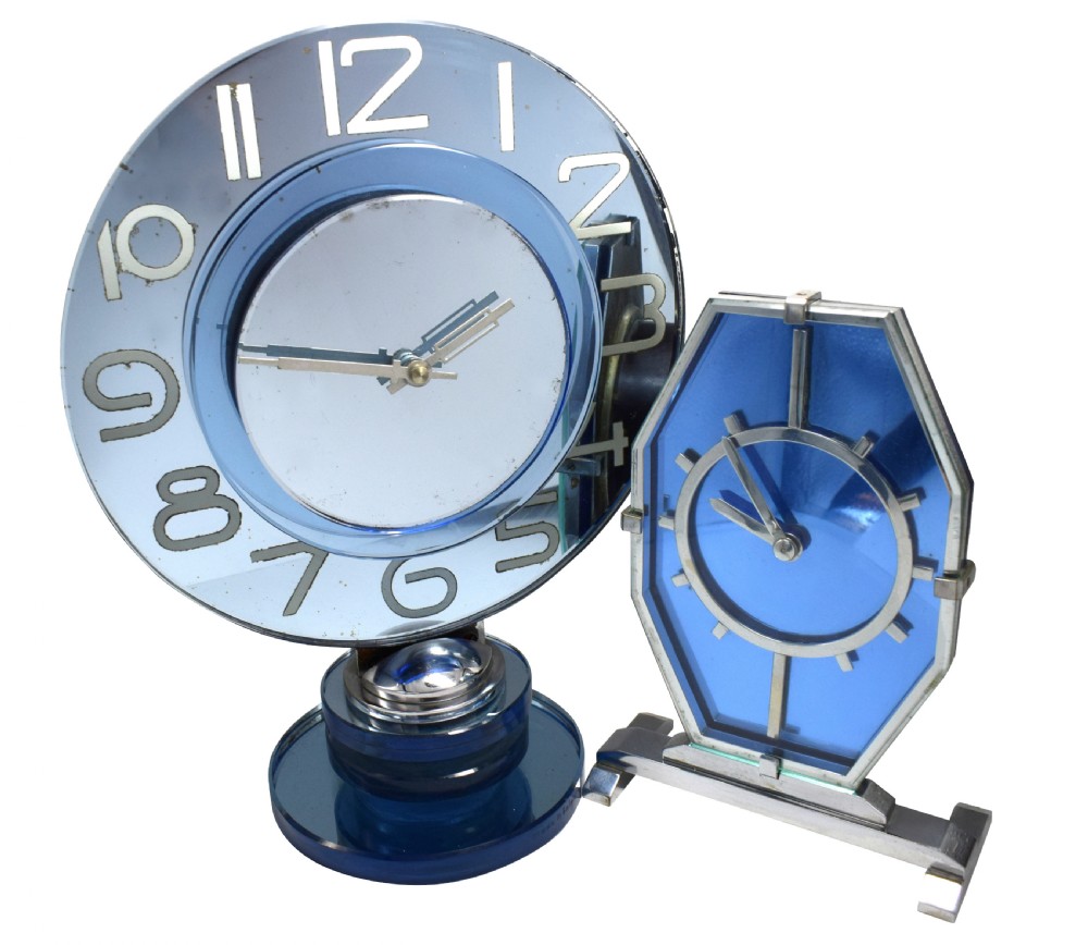 A circular Art Deco table clock made from blue mirrored glass featuring silvered numbers and a stepped circular glass base. View III