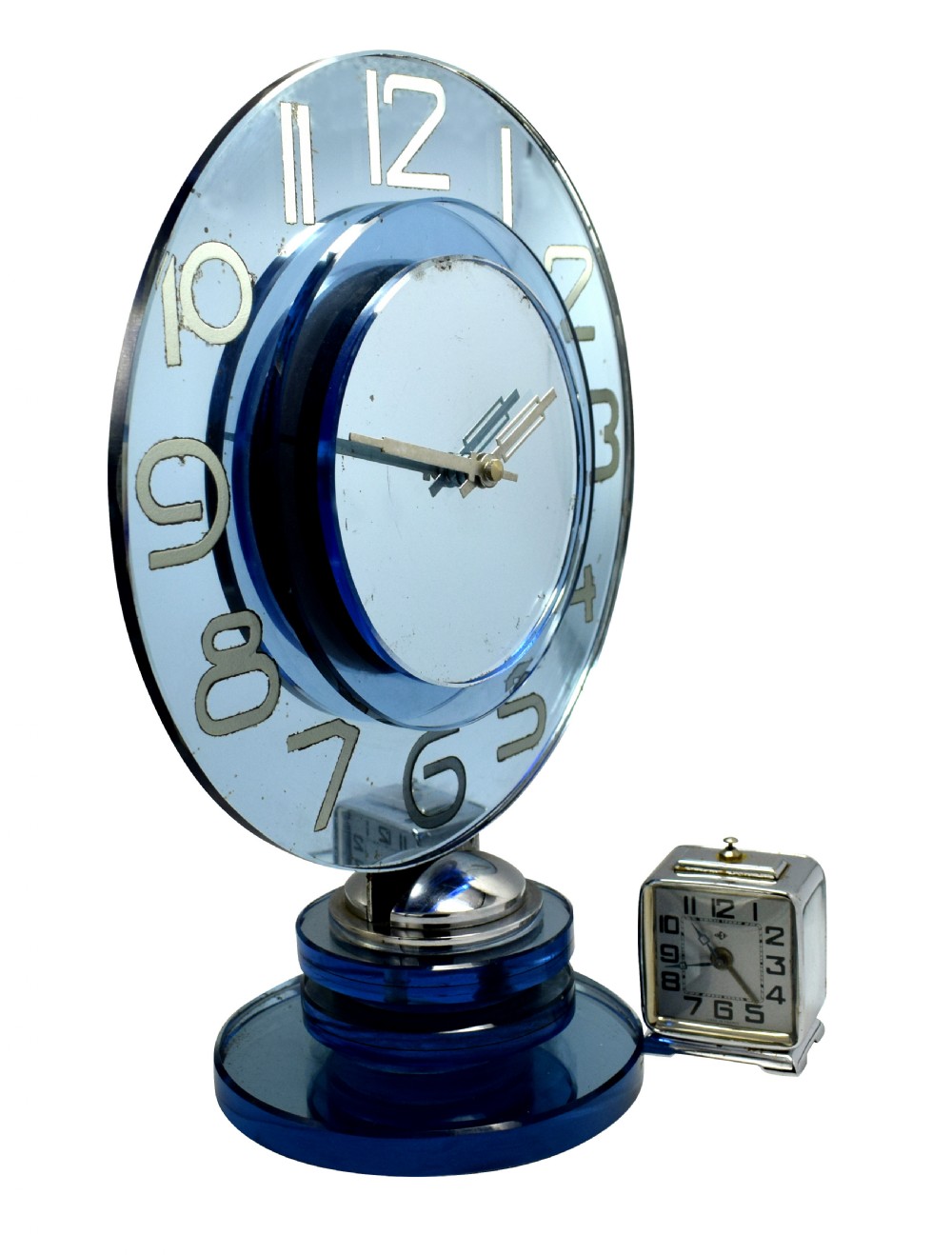 A circular Art Deco table clock made from blue mirrored glass featuring silvered numbers and a stepped circular glass base. View V