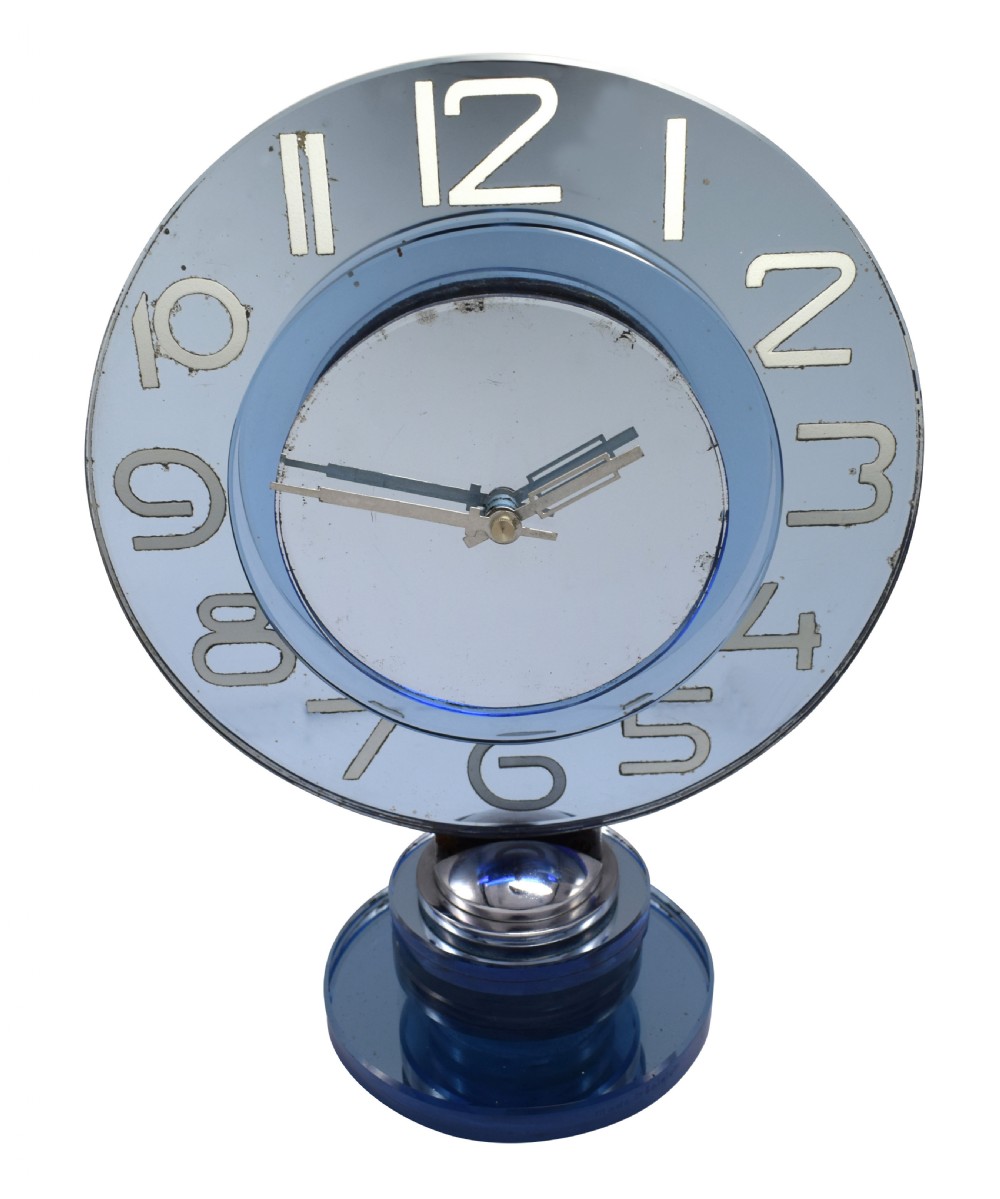 A circular Art Deco table clock made from blue mirrored glass featuring silvered numbers and a stepped circular glass base. View XIII