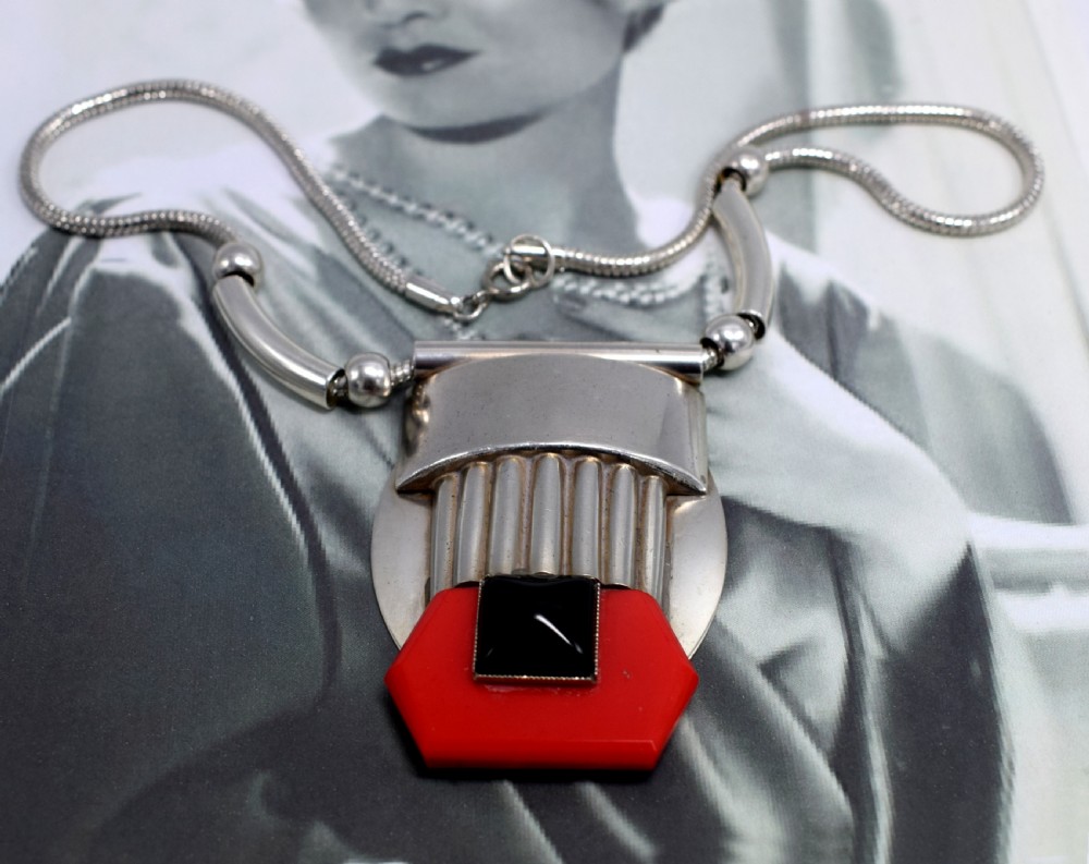 An Art Deco snake chain necklace featuring a geometric silver-tone pendant set with a red Galalith element and a central square black cabochon. View IV