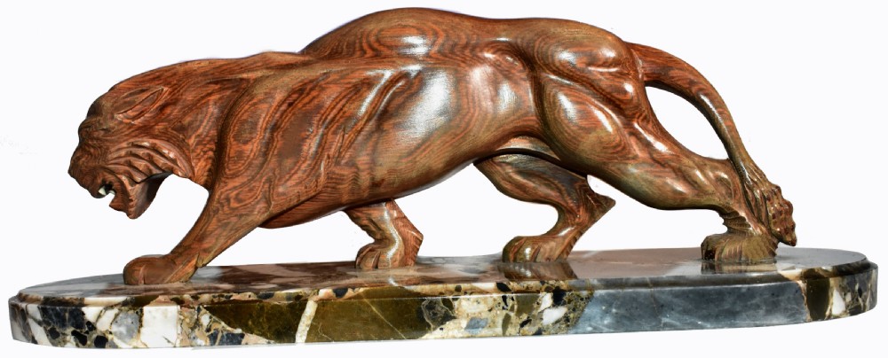 A stylised Art Deco sculpture of a prowling panther crafted from reddish-brown veined stone mounted on a variegated marble plinth. View VII