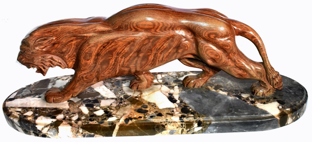 A stylised Art Deco sculpture of a prowling panther crafted from reddish-brown veined stone mounted on a variegated marble plinth. View VIII