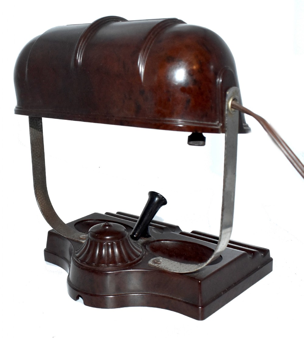 A dark brown mottled Bakelite desk lamp featuring a ribbed dome shade, curved metal arm, and an integrated pen tray base. View III