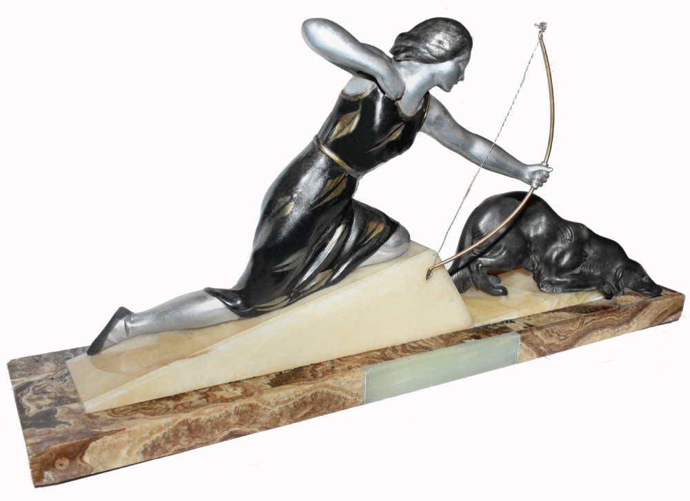 An Art Deco cold-painted metal sculpture depicting a female archer kneeling with a bow alongside a dog on a stepped onyx and marble base. View IV