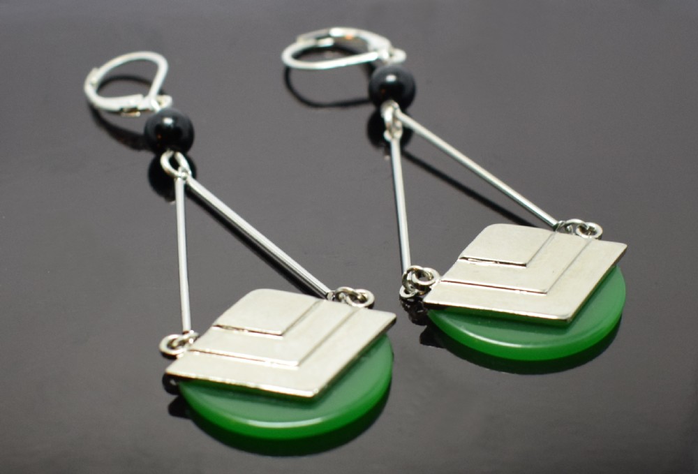 A pair of Art Deco drop earrings featuring green semicircular Bakelite disks topped with stepped geometric chrome motifs and lever-back hooks. View IV