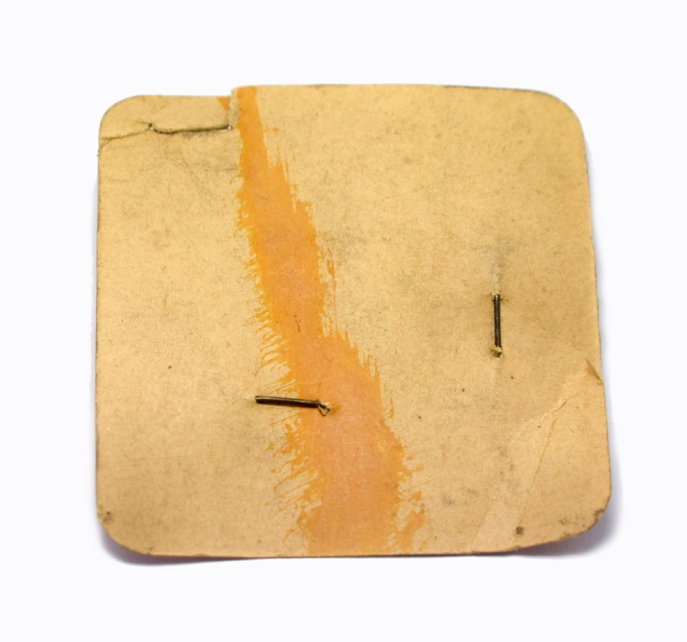 A 1930s Art Deco celluloid novelty brooch depicting a figure walking a spotted dog linked by a small metal chain. View VIII