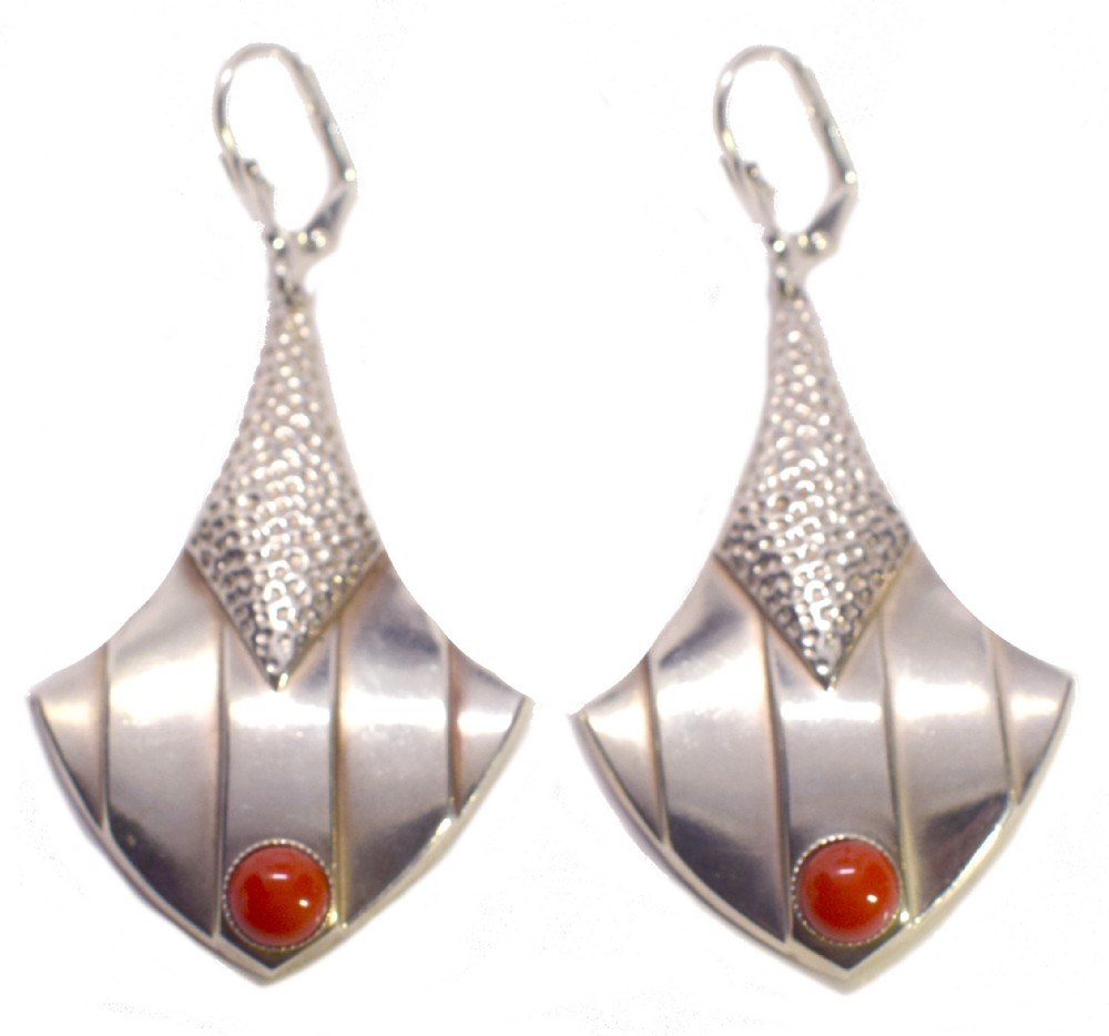 Pair of Art Deco silver drop earrings featuring stippled triangular upper sections, fan-shaped lower panels, and circular red cabochon stones.