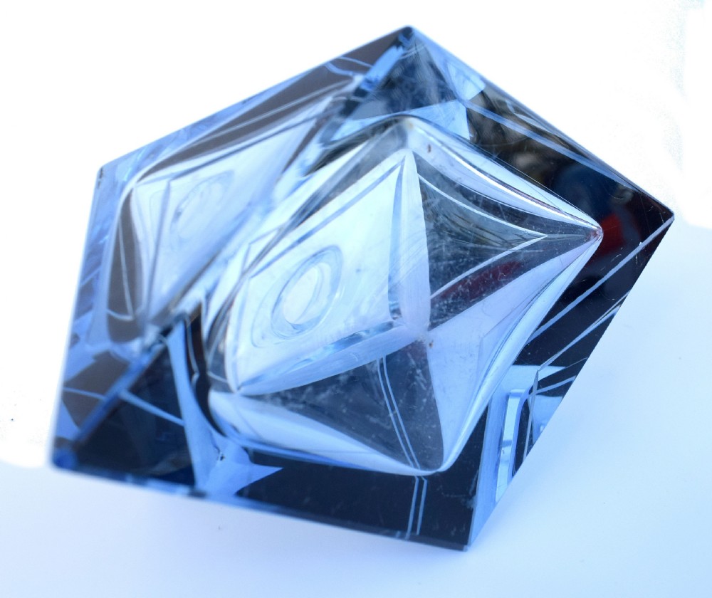 An Art Deco light blue glass vanity set consisting of a geometric scent bottle with a tall stopper and a matching powder box decorated with black triangular detailing. View V