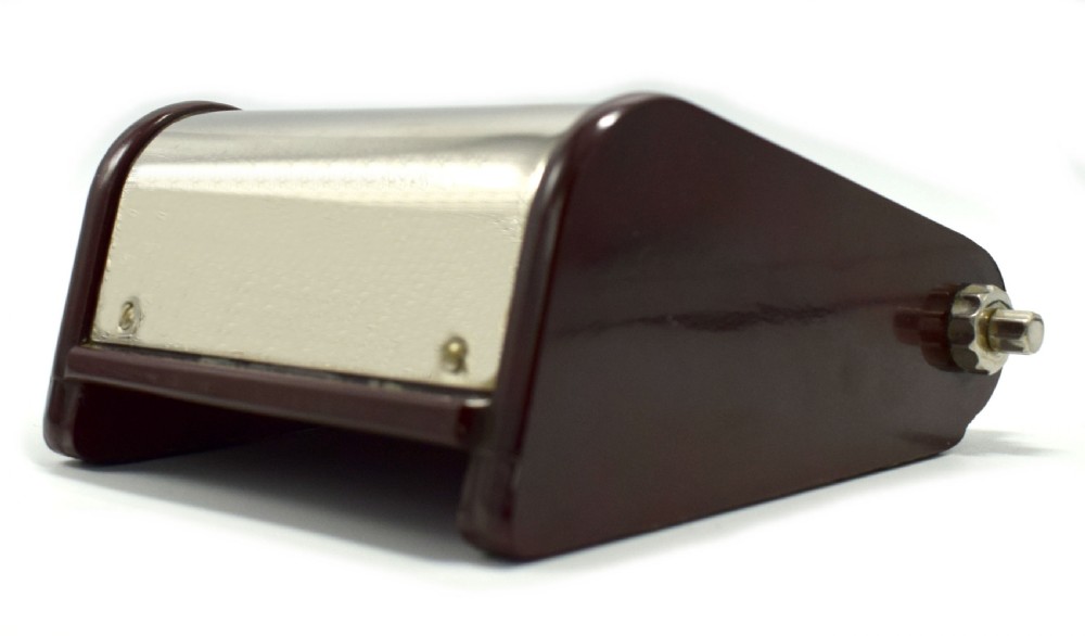 An Art Deco Hungarian desk clock featuring burgundy Bakelite side panels, a polished chrome casing, a square black dial, and integrated day and month calendar displays. View II