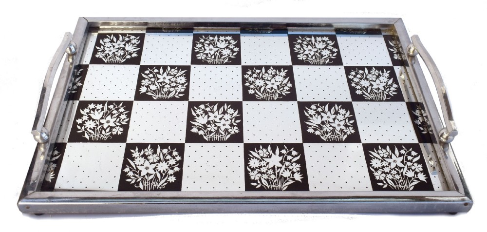 A rectangular Art Deco chrome drinks tray featuring a black and white checkerboard mirrored glass surface decorated with floral motifs and geometric dots.