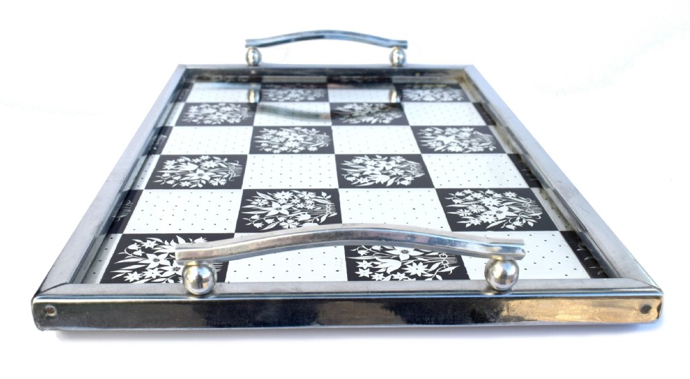 A rectangular Art Deco chrome drinks tray featuring a black and white checkerboard mirrored glass surface decorated with floral motifs and geometric dots. View IV