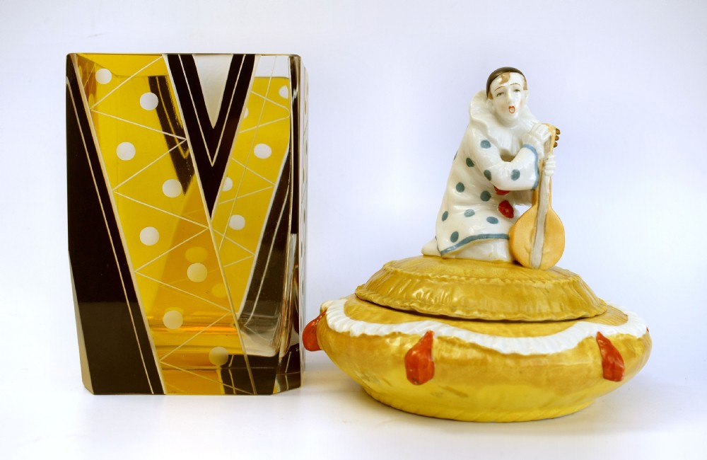 A yellow glazed porcelain powder bowl topped with a lid sculpted as a Pierrot character kneeling and playing a lute. View IX
