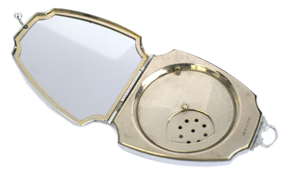 An Art Deco fan-shaped chrome powder compact with geometric blue, light blue, and black enamel panels and engine-turned metal details. View IV