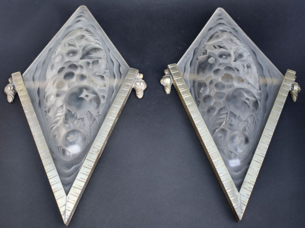 A pair of diamond-shaped Art Deco wall sconces featuring frosted glass with fruit relief designs held in incised bronze mounts. View II