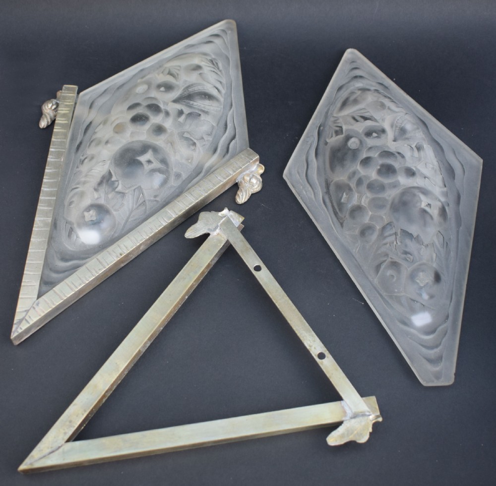 A pair of diamond-shaped Art Deco wall sconces featuring frosted glass with fruit relief designs held in incised bronze mounts. View III