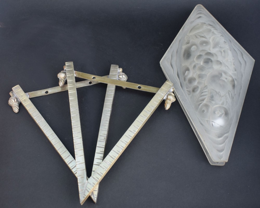 A pair of diamond-shaped Art Deco wall sconces featuring frosted glass with fruit relief designs held in incised bronze mounts. View IV