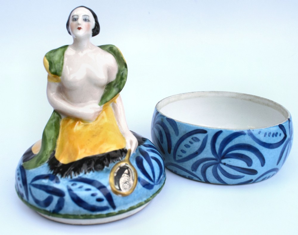 An Art Deco French Limoges glazed porcelain powder box featuring a lidded base with blue abstract pattern topped by a stylised female figure. View II
