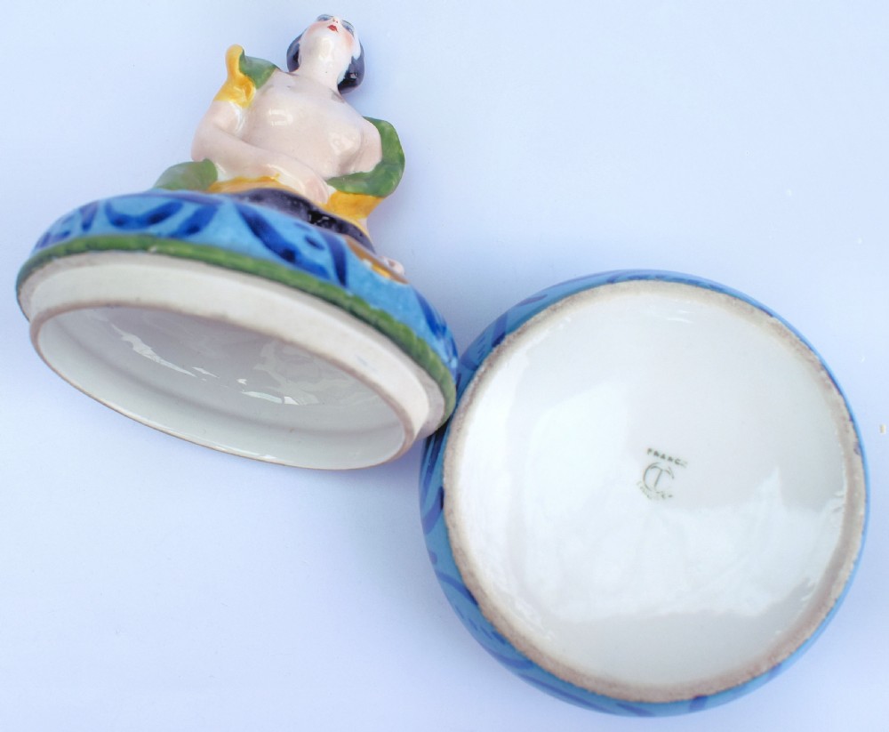 An Art Deco French Limoges glazed porcelain powder box featuring a lidded base with blue abstract pattern topped by a stylised female figure. View III