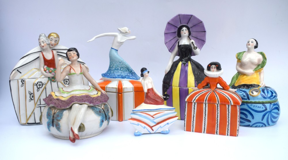 An Art Deco French Limoges glazed porcelain powder box featuring a lidded base with blue abstract pattern topped by a stylised female figure. View VI