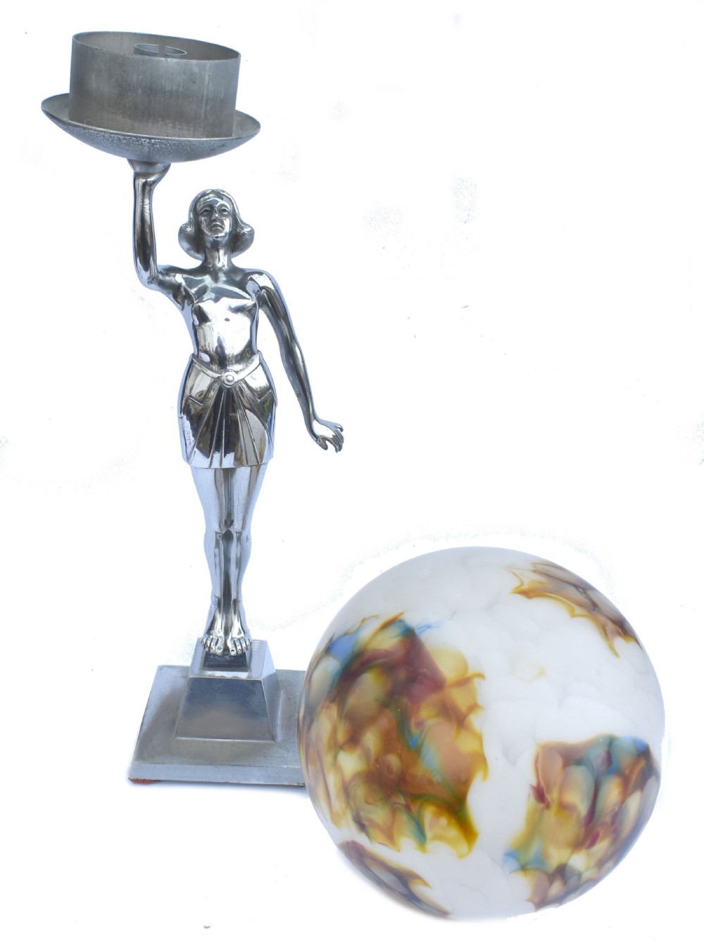 An Art Deco chrome table lamp featuring a stylised female figure holding a spherical mottled glass globe shade above her head on a stepped base. View V