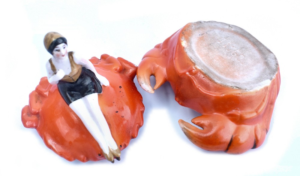 An Art Deco porcelain novelty powder bowl shaped as an orange crab with a bathing belle figure seated on its shell. View VI