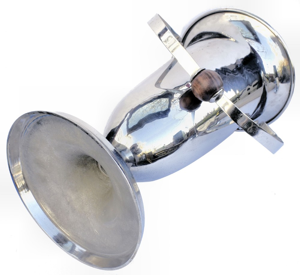 A tall polished chrome ice bucket featuring a pedestal base, flared top rim, and a curved swing handle with a turned wooden centre knob. View III