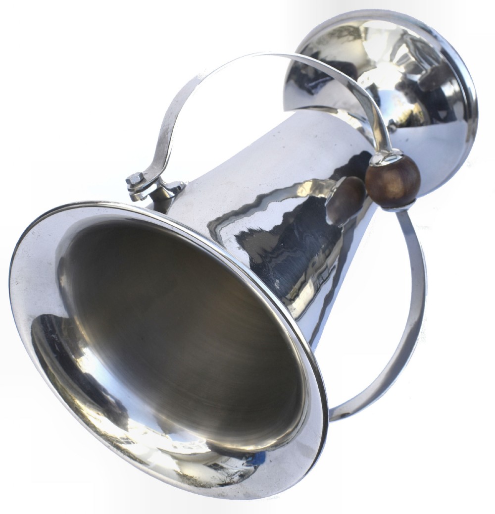 A tall polished chrome ice bucket featuring a pedestal base, flared top rim, and a curved swing handle with a turned wooden centre knob. View V