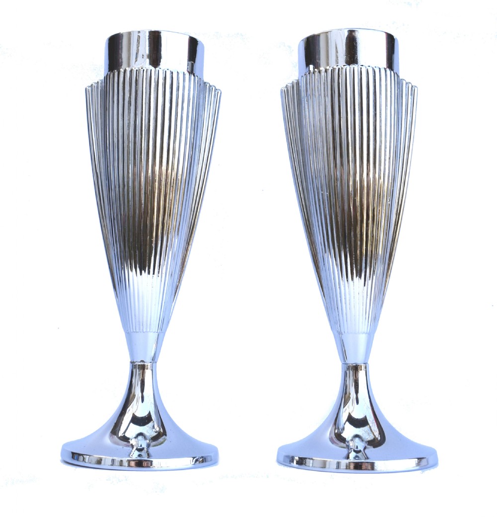 A pair of polished chrome Art Deco vases featuring fluted conical bodies set upon flared pedestal bases.