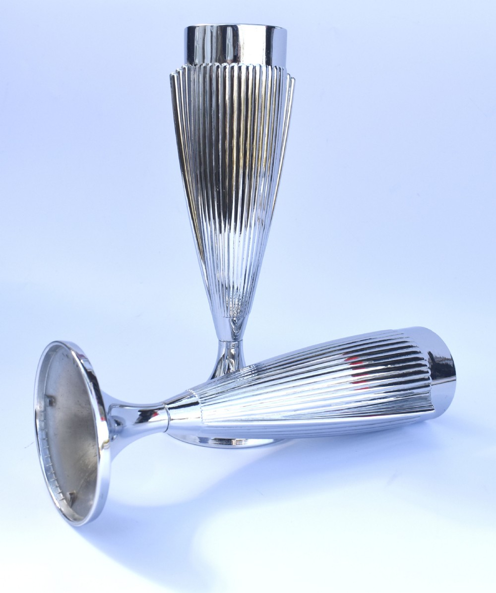 A pair of polished chrome Art Deco vases featuring fluted conical bodies set upon flared pedestal bases. View VI