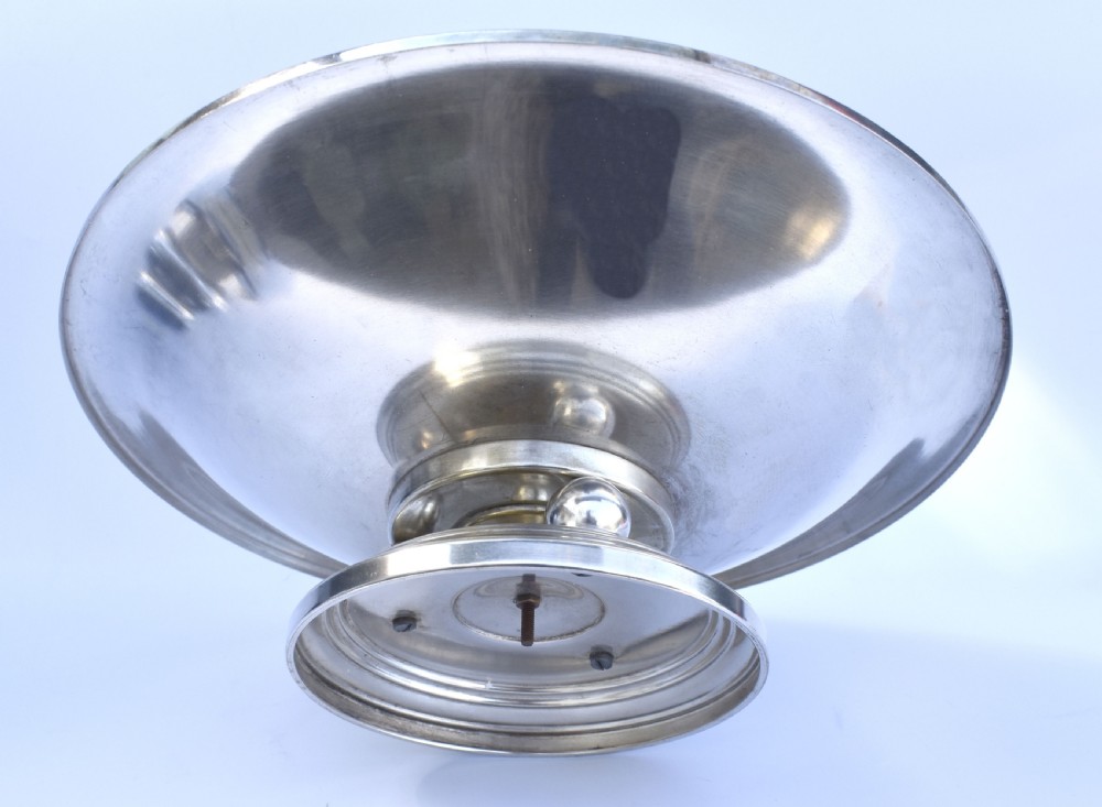 A shallow Art Deco chrome bowl supported by three spherical metal ball feet set on a stepped circular pedestal base. View IV