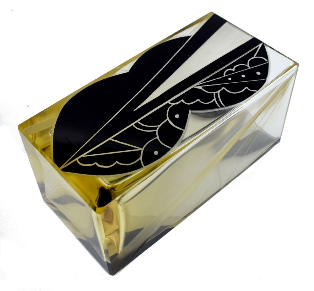 A rectangular Art Deco clear glass vase with a yellow hue, decorated with a stylised geometric black and etched enamel design. View VI