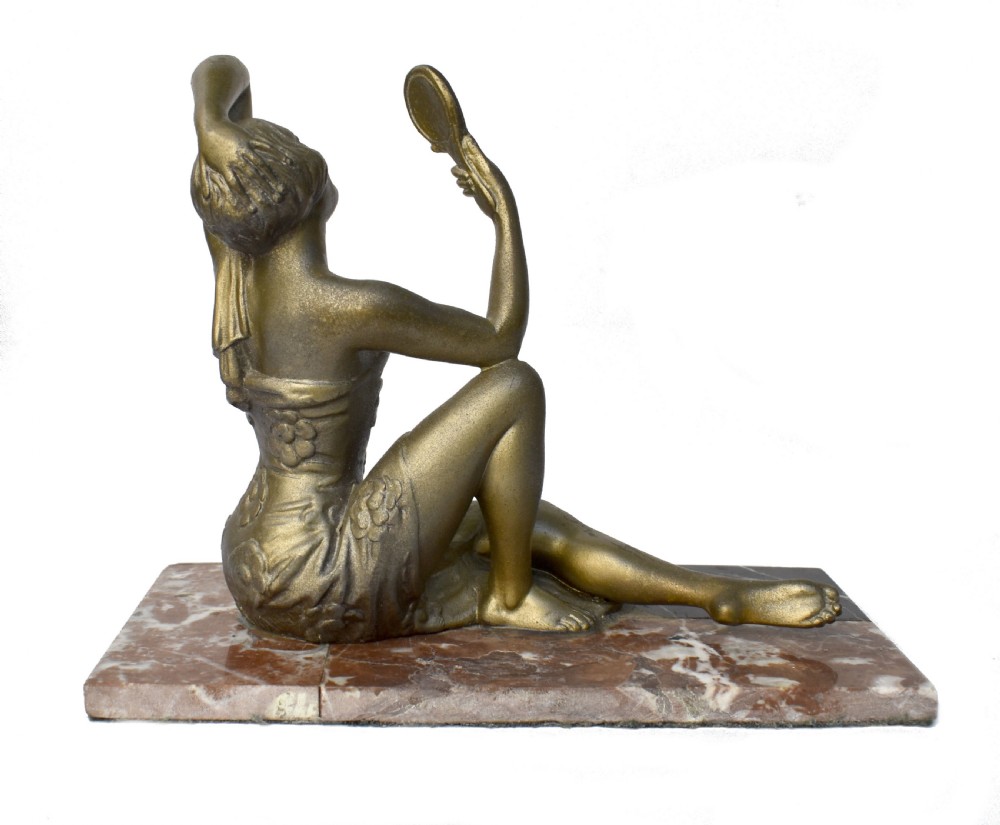 An Art Deco patinated metal figure of a seated woman holding a hand mirror, resting on a marble base. View III