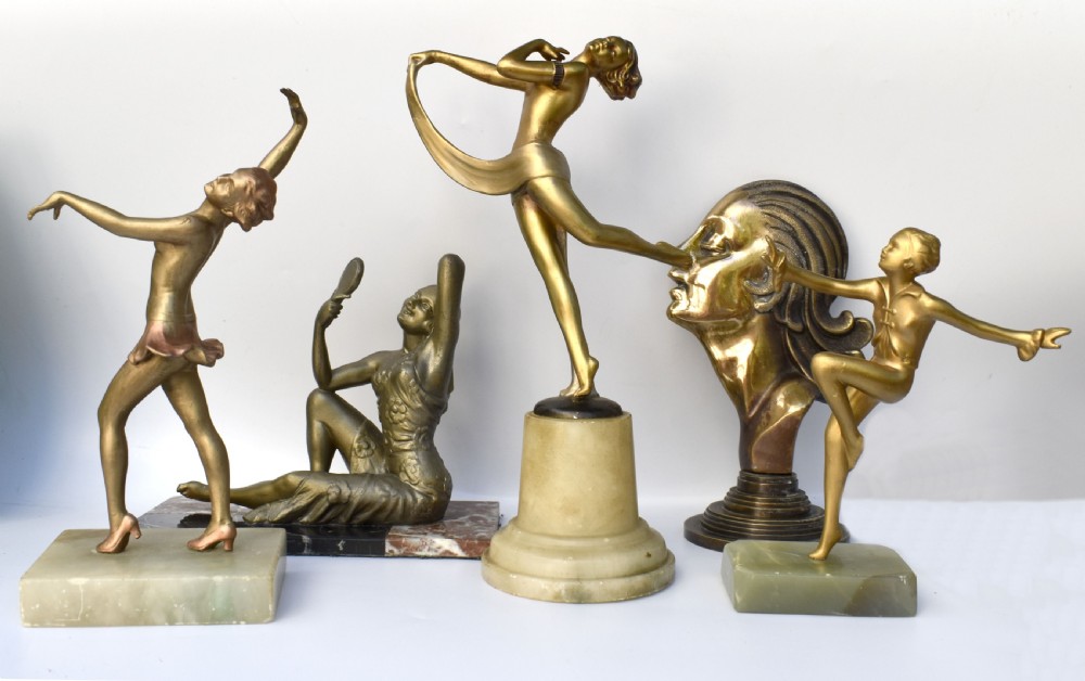 An Art Deco patinated metal figure of a seated woman holding a hand mirror, resting on a marble base. View VI