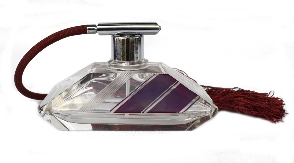 An Art Deco cut clear crystal glass perfume atomizer featuring a burgundy geometric inlay panel, chrome metal fitting, and a maroon fabric bulb with a fringe tassel. View II