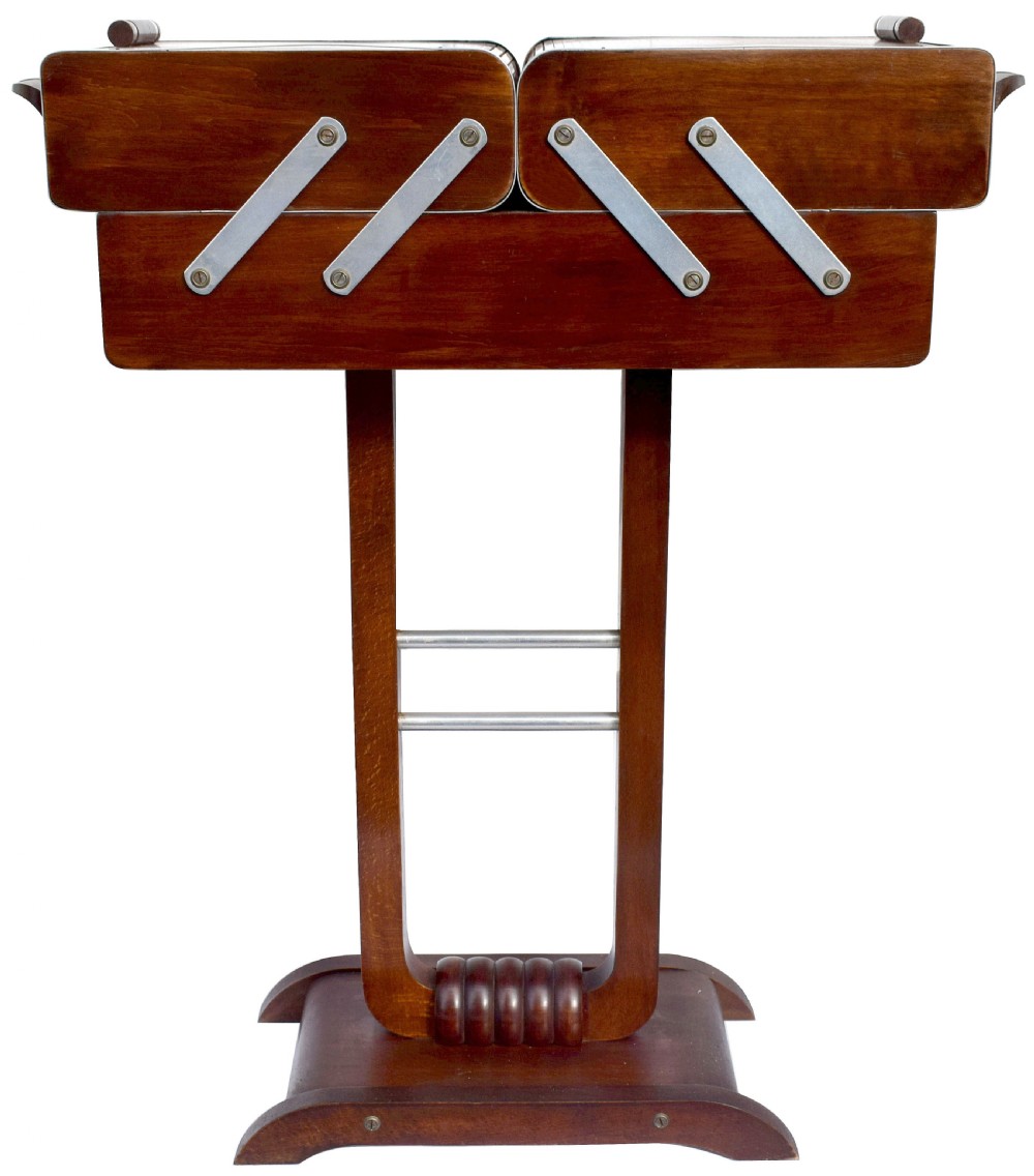 An Art Deco wooden cantilever sewing box on a pedestal stand with metallic joint brackets and cylindrical handles. View II