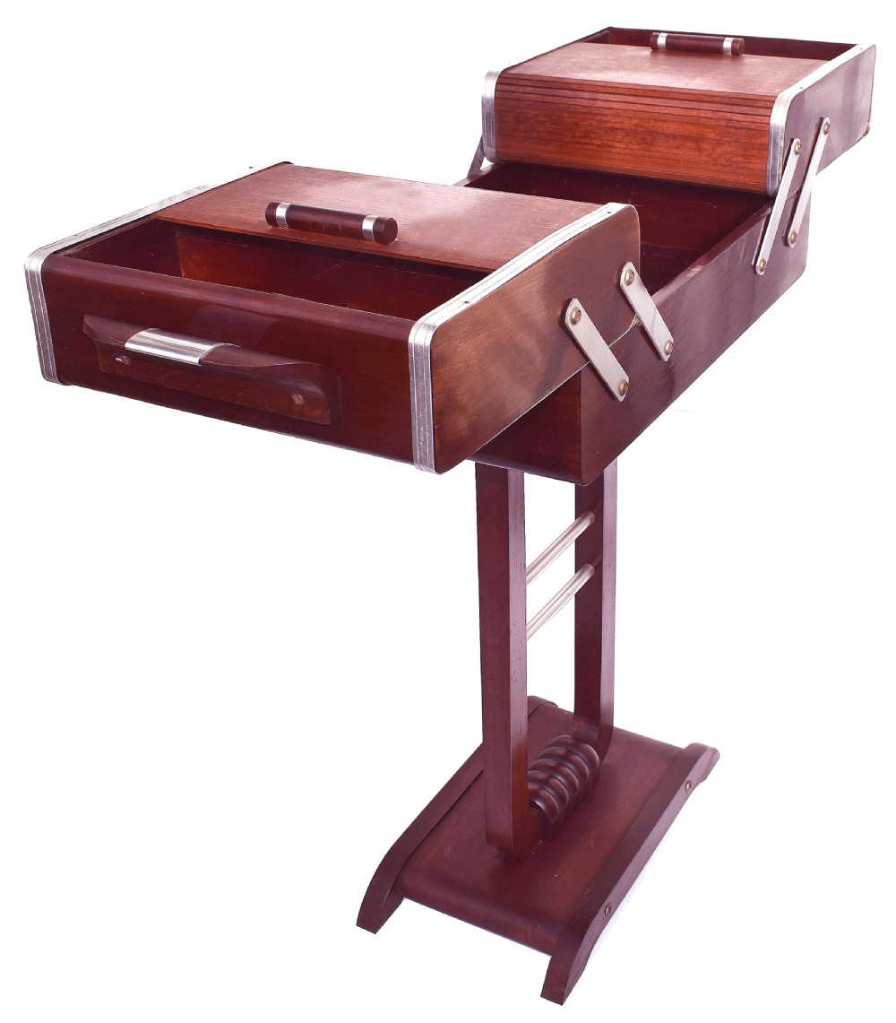 An Art Deco wooden cantilever sewing box on a pedestal stand with metallic joint brackets and cylindrical handles. View XIV