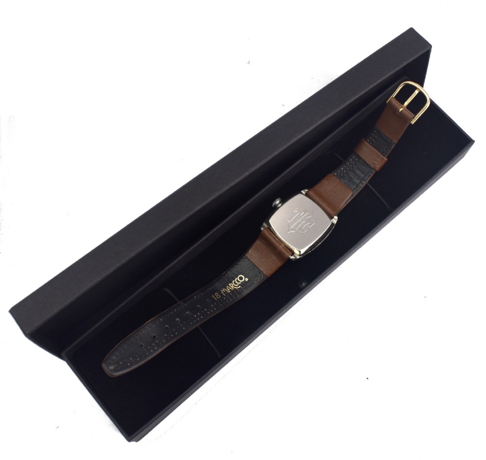 An Art Deco Elgin gentlemans wrist watch featuring a cushion-shaped 14k white gold case, cream dial with black Arabic numerals, small seconds dial, and a stitched brown leather strap. View VII