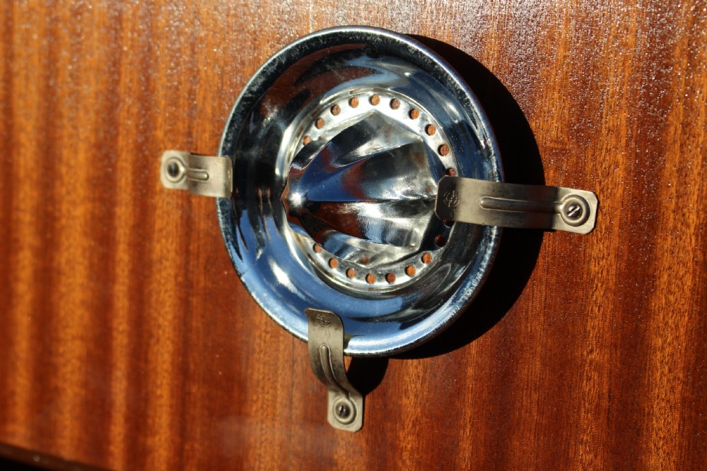 An Art Deco walnut cocktail cabinet featuring figure-matched timber grain, a drop-front upper section, double lower doors, and streamlined handles. View VIII